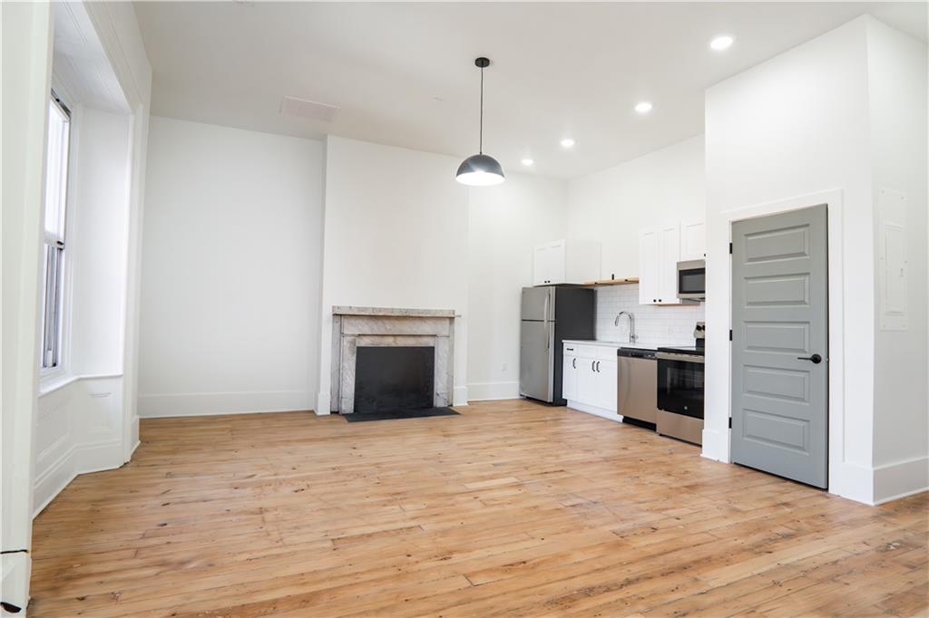 4402 Butler Street Pittsburgh, PA 15201 - Photo 15 of 28 a view of an empty room with kitchen and window