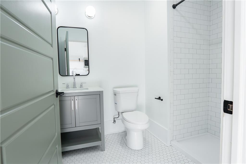 4402 Butler Street Pittsburgh, PA 15201 - Photo 20 of 28 a bathroom with a toilet sink and shower