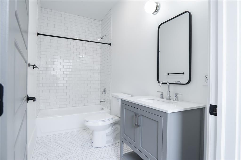 4402 Butler Street Pittsburgh, PA 15201 - Photo 22 of 28 a bathroom with a sink toilet double vanity and shower