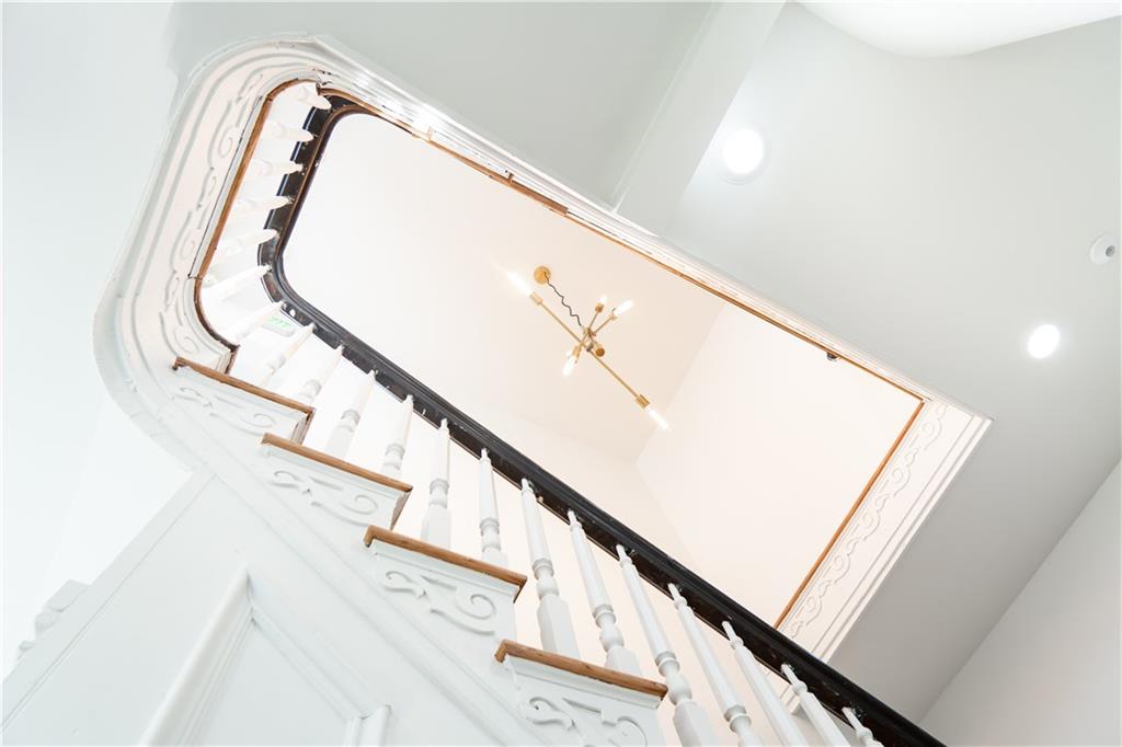 4402 Butler Street Pittsburgh, PA 15201 - Photo 4 of 28 a view of staircase with white walls and stairs