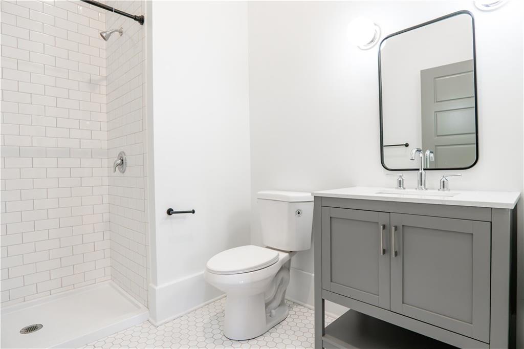 4402 Butler Street Pittsburgh, PA 15201 - Photo 6 of 28 a bathroom with a toilet sink and mirror