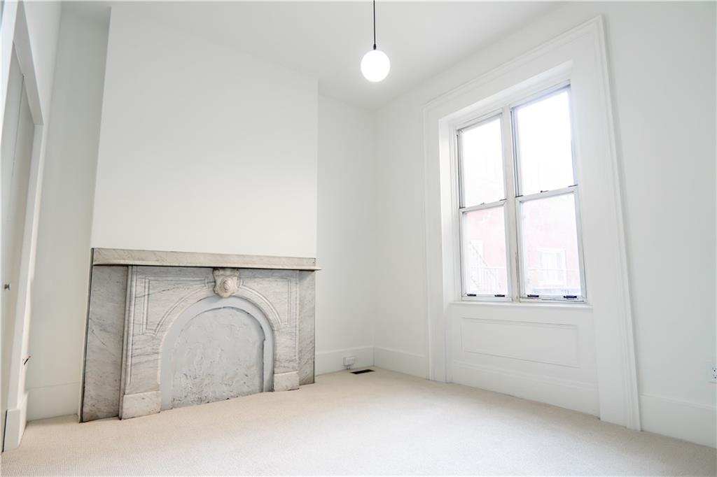 4402 Butler Street Pittsburgh, PA 15201 - Photo 8 of 28 an empty room with wooden floor and windows
