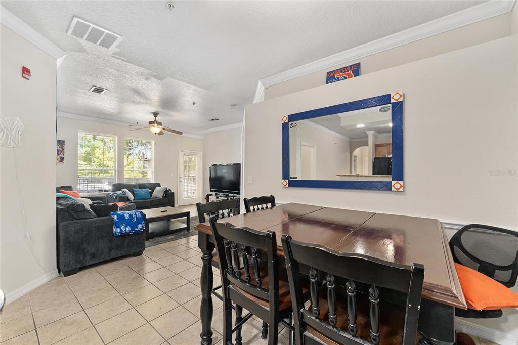 1142 Southwest 9th Road, Unit 103 Gainesville, FL 32601 - Photo 14 of 40 a living room with furniture and a flat screen tv