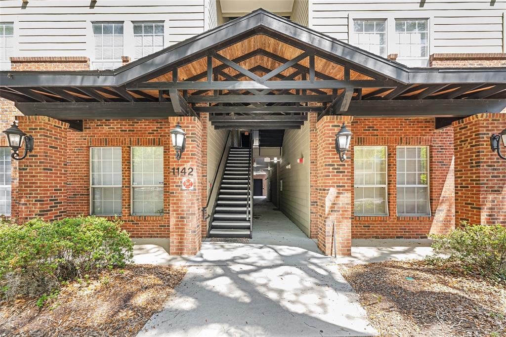 1142 Southwest 9th Road, Unit 103 Gainesville, FL 32601 - Photo 2 of 40 a view of a house with a door and wooden walls