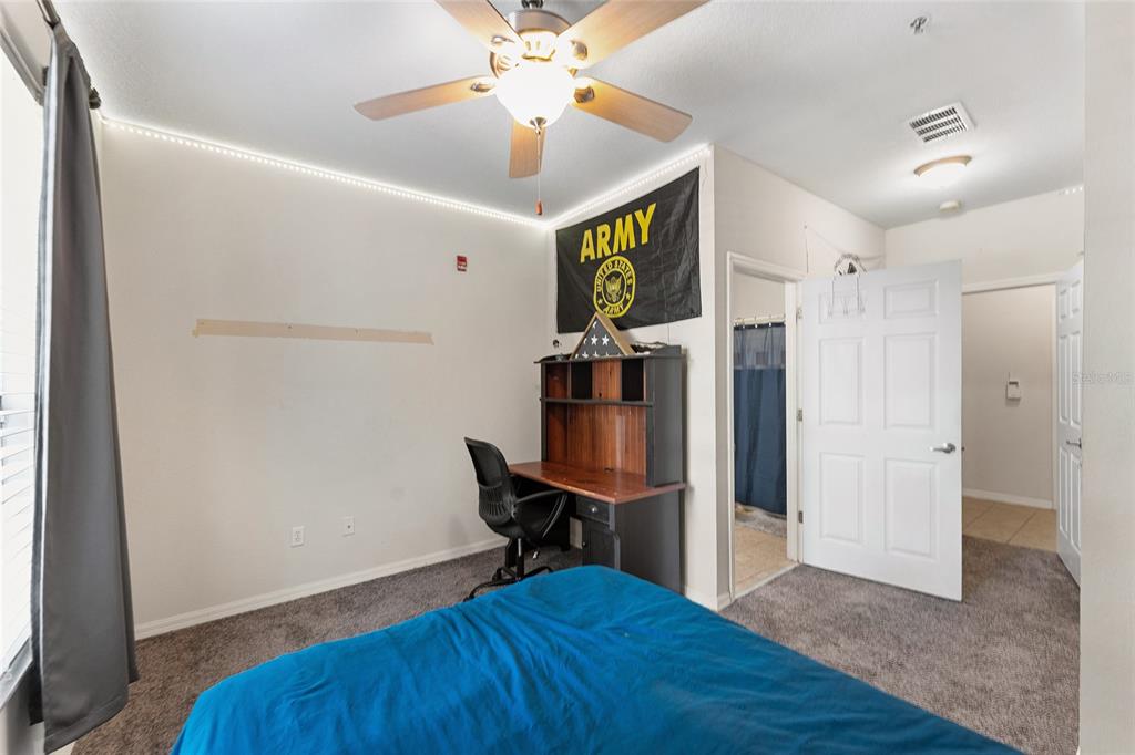 1142 Southwest 9th Road, Unit 103 Gainesville, FL 32601 - Photo 22 of 40 a view of a workspace with furniture and wooden floor