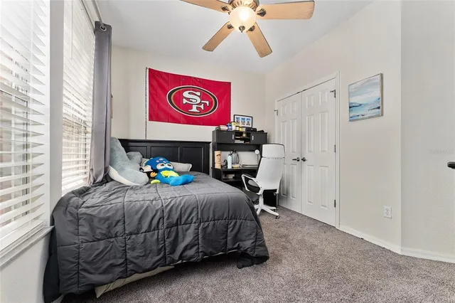 a bed room with a bed and a chair