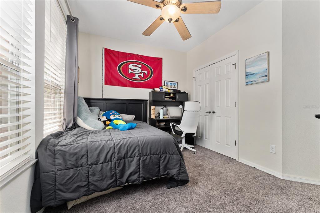 1142 Southwest 9th Road, Unit 103 Gainesville, FL 32601 - Photo 29 of 40 a bedroom with a bed and a chandelier