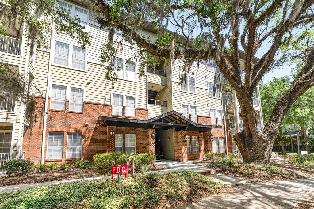 1142 Southwest 9th Road, Unit 103 Gainesville, FL 32601 - Photo 37 of 40 a front view of a house with a yard