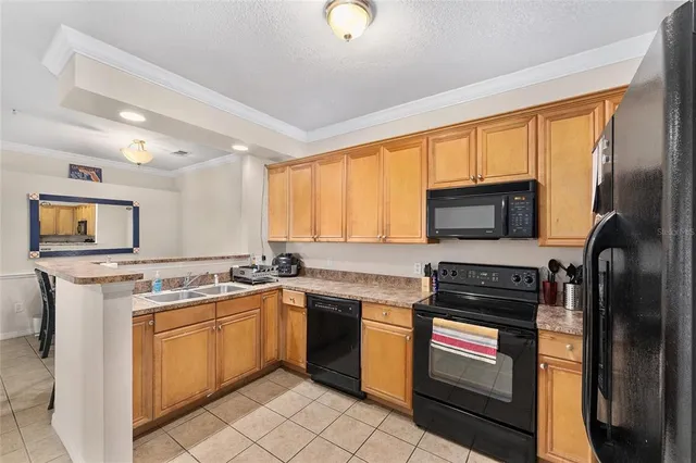 a kitchen with a stove sink and cabinets