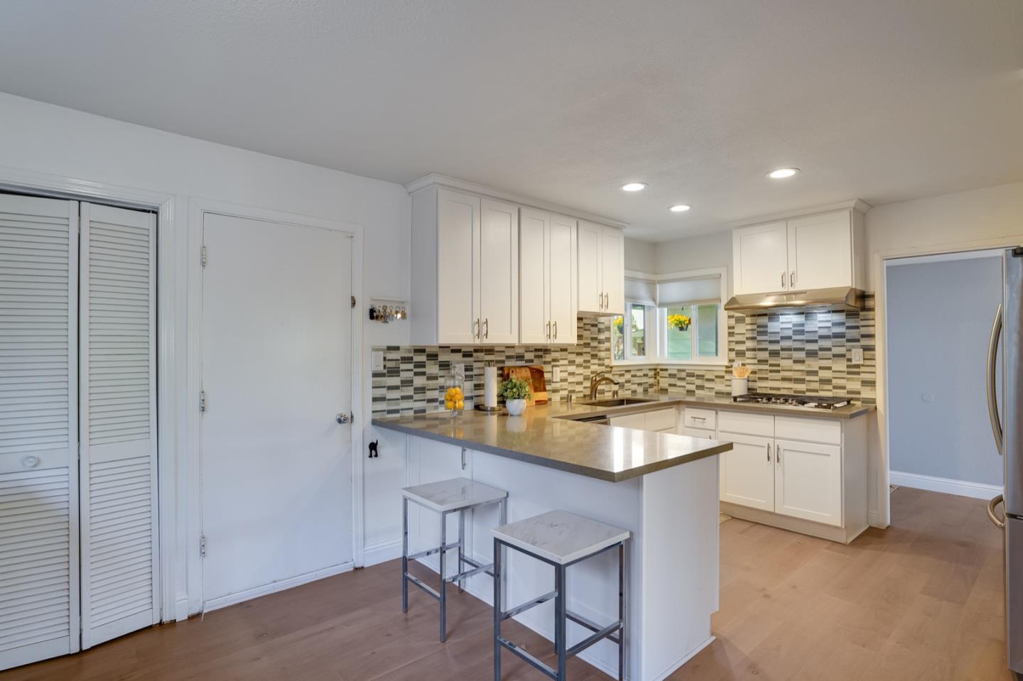 3143 Kermath Drive San Jose, CA 95132 - Photo 12 of 62 a kitchen with kitchen island granite countertop wooden cabinets a refrigerator sink and stove
