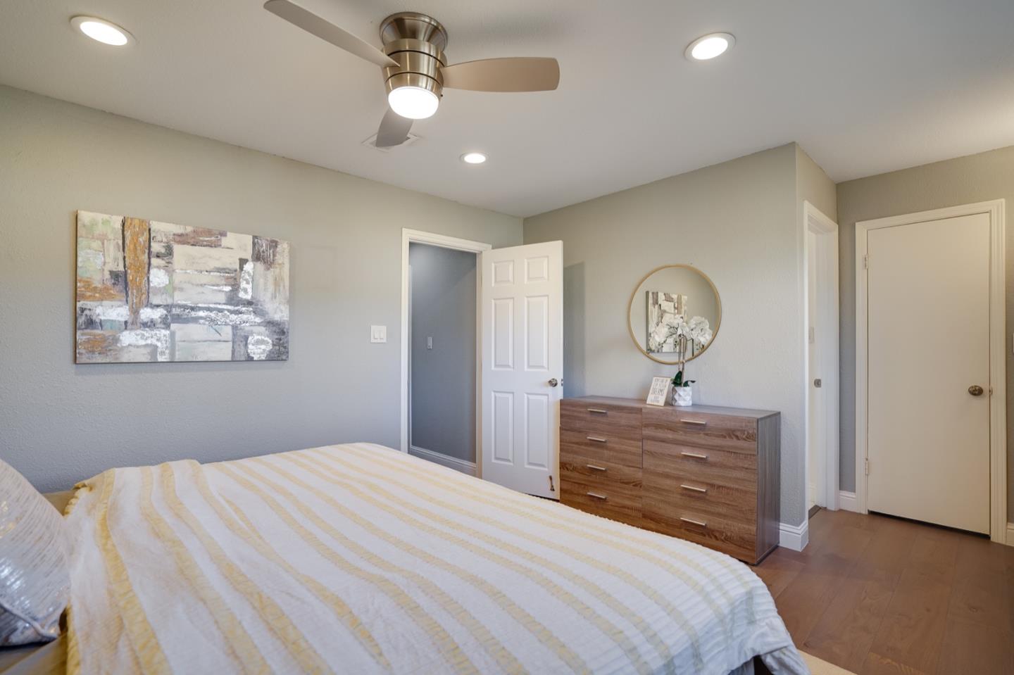 3143 Kermath Drive San Jose, CA 95132 - Photo 29 of 62 a bedroom with a large bed and a chandelier