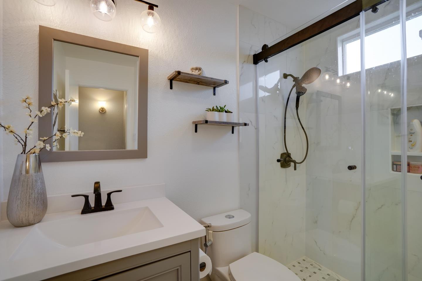 3143 Kermath Drive San Jose, CA 95132 - Photo 39 of 62 a bathroom with a sink vanity granite toilet and a mirror