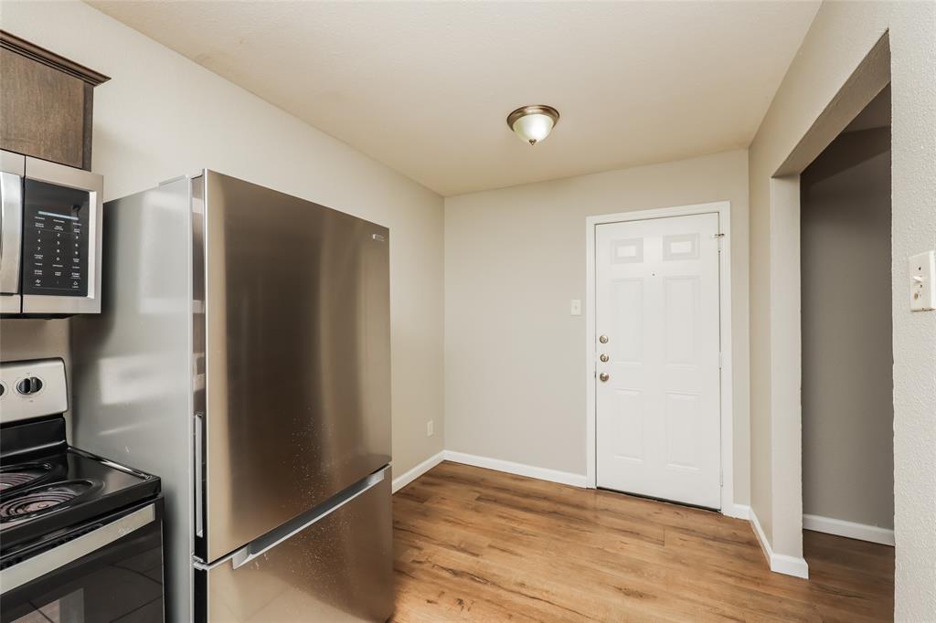 4618 Reiger Avenue, Unit 104 Dallas, TX 75246 - Photo 10 of 19 a view of a kitchen with wooden floor and electronic appliances