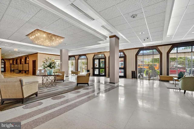 a lobby with furniture and large windows