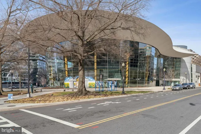 a view of a patio with couches and table and chairs under an umbrella