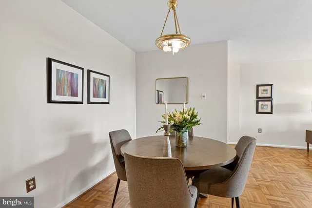 a dining room with furniture and chandelier