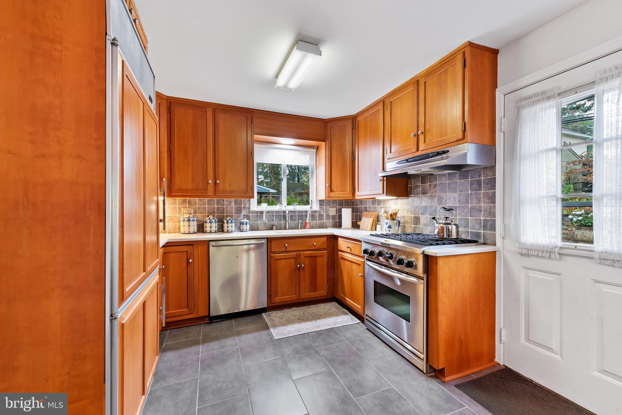 706 Murdock Road Baltimore, MD 21212 - Photo 15 of 39 a kitchen with stainless steel appliances granite countertop a stove a sink and a refrigerator