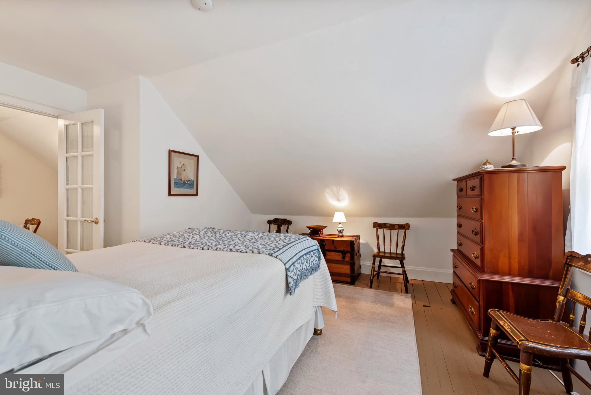 706 Murdock Road Baltimore, MD 21212 - Photo 22 of 39 a spacious bedroom with a bed and a table in it