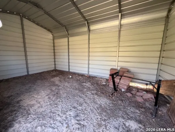 a view of a backyard with chairs and a table