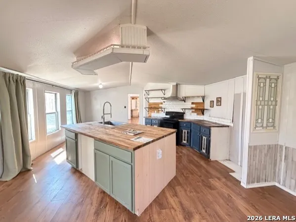 a kitchen with stainless steel appliances granite countertop a stove and a refrigerator