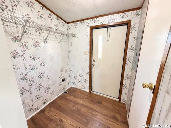 a view of bathroom with wooden floor and mirror