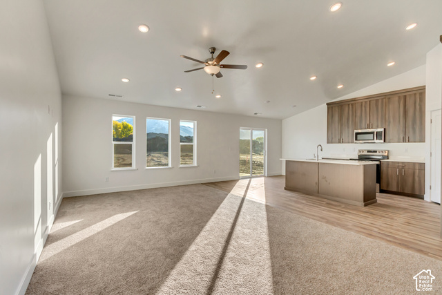 3357 South 960 West Logan, UT 84321 - Photo 3 of 17 Open-concept living space featuring recessed ceiling lighting, a brushed-metal ceiling fan, and abundant natural light from multi-pane windows and glass sliding doors