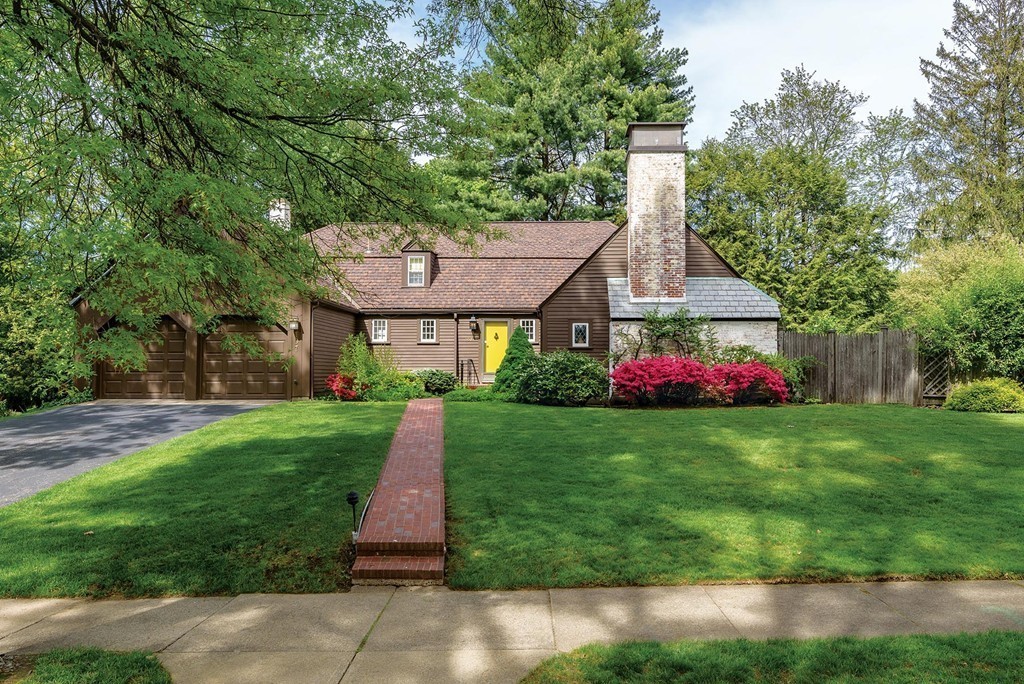 a front view of a house with a yard and pathway