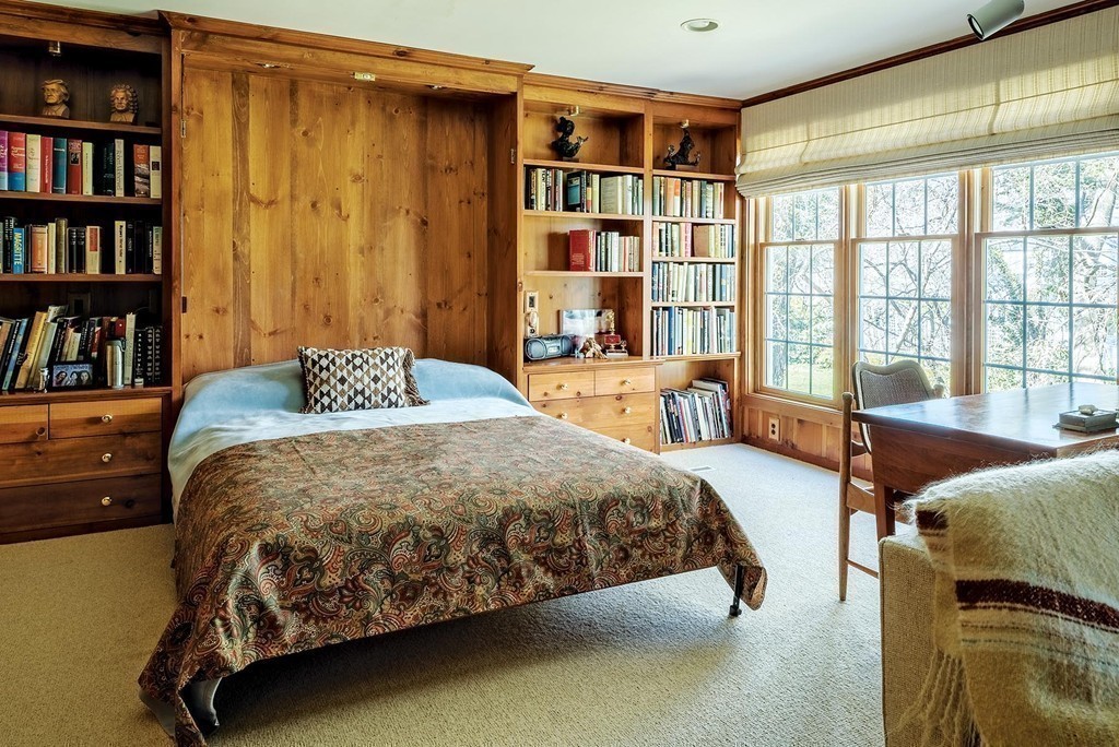 107 Arnold Road Newton, MA 02459 - Photo 7 of 18 a bedroom with a bed furniture and a book shelf