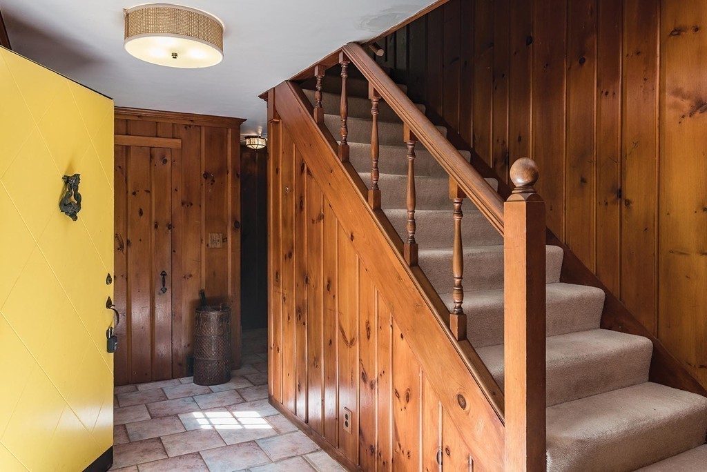 107 Arnold Road Newton, MA 02459 - Photo 9 of 18 a view of a hallway with wooden floor and staircase