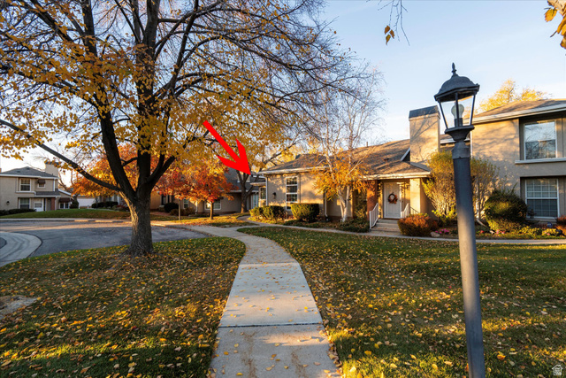 888 East 6895 South Midvale, UT 84047 - Photo 25 of 54 Charming exterior with tree-lined walkways and mature landscaping, highlighting the unit’s location within the community.