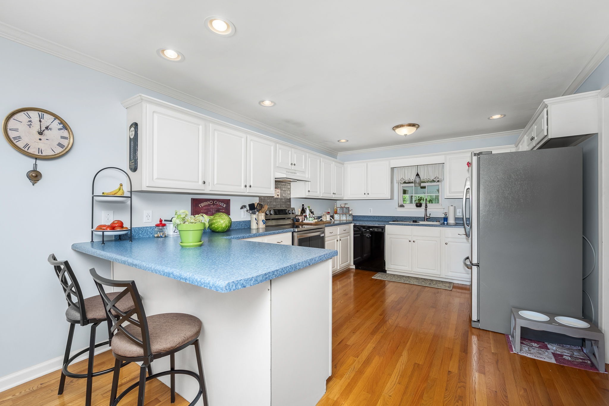 4330 River Lane Milton, TN 37118 - Photo 13 of 44 a kitchen with stainless steel appliances granite countertop a refrigerator a sink dishwasher a stove top oven a dining table and chairs with wooden floor