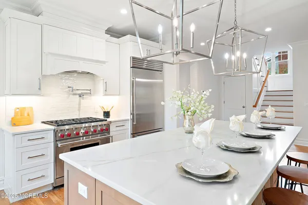 a large kitchen with a table and chairs in it