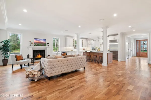 a living room with furniture a fireplace and a flat screen tv