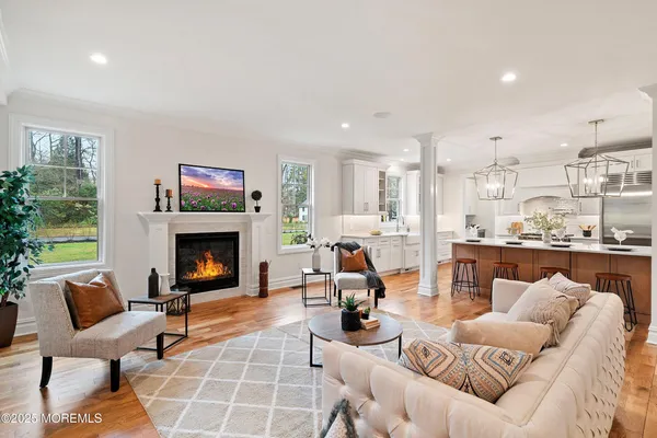 a living room with furniture and wooden floor
