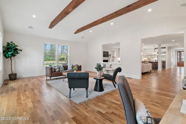 a view of an empty room with wooden floor and entryway