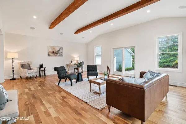a view of a room with wooden floor and a window