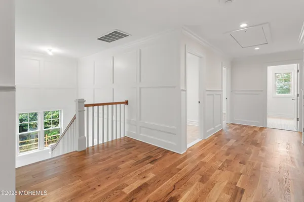 a front view of a house with a garden and plants