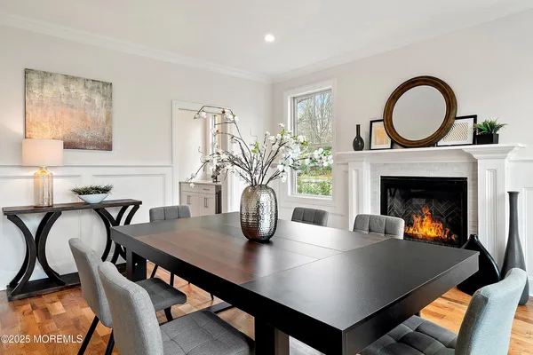 a view of a kitchen with kitchen island stainless steel appliances a sink table and chairs
