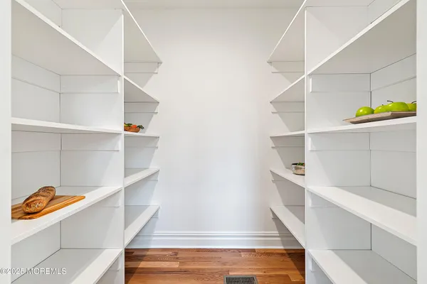 a kitchen with stainless steel appliances a table and chairs in it