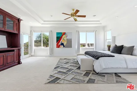 a bed room with a bed and a chandelier