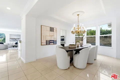 a large kitchen with stainless steel appliances kitchen island granite countertop a refrigerator and a sink