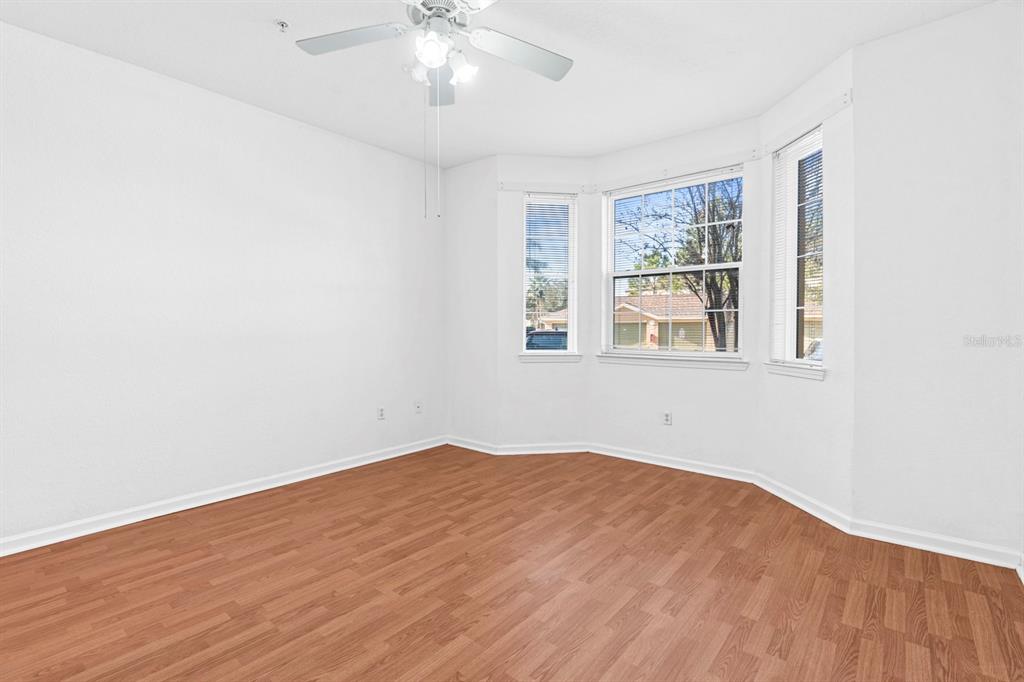 707 Terrace Ridge Circle, Unit 707 Davenport, FL 33896 - Photo 12 of 59 a view of empty room with wooden floor and fan