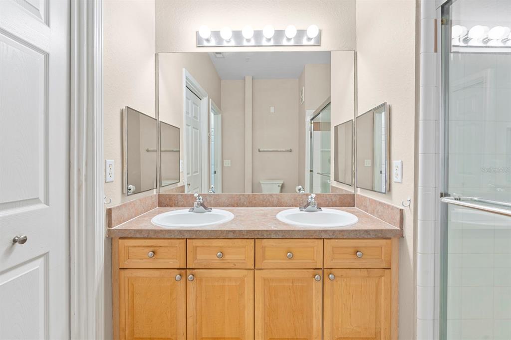 707 Terrace Ridge Circle, Unit 707 Davenport, FL 33896 - Photo 16 of 59 a bathroom with a granite countertop sink and a mirror