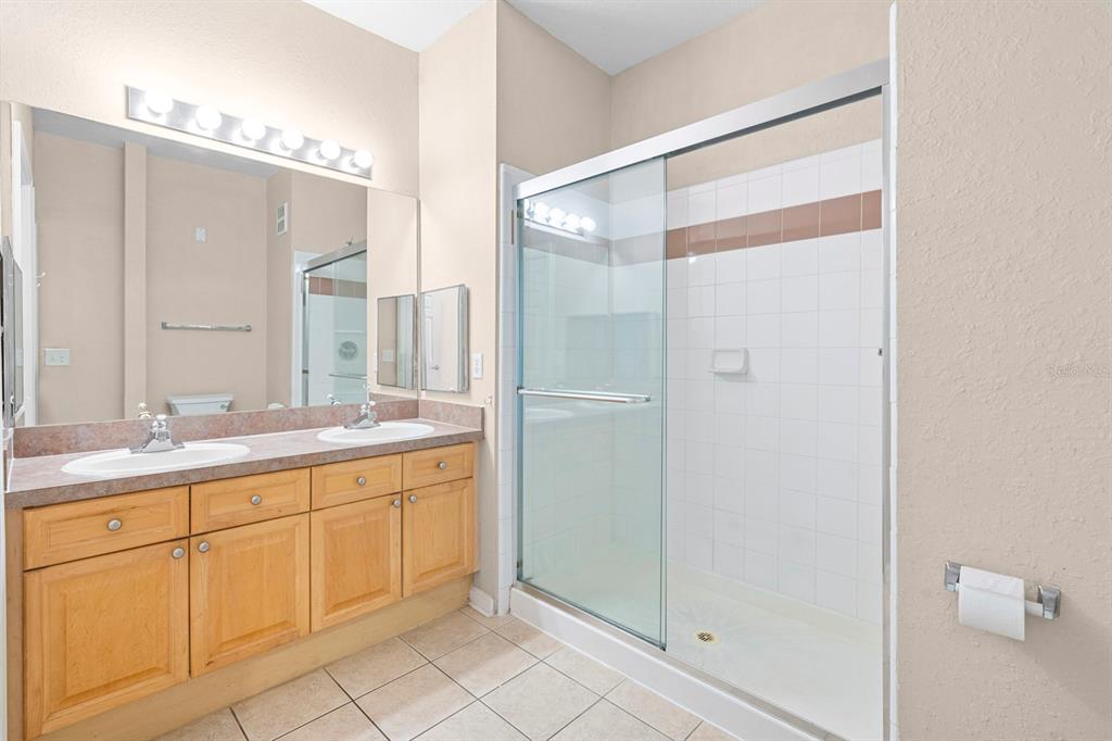 707 Terrace Ridge Circle, Unit 707 Davenport, FL 33896 - Photo 17 of 59 a bathroom with a double vanity sink and a mirror