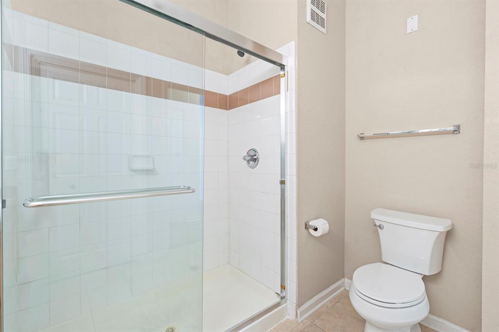 707 Terrace Ridge Circle, Unit 707 Davenport, FL 33896 - Photo 18 of 59 a bathroom with a toilet and a shower