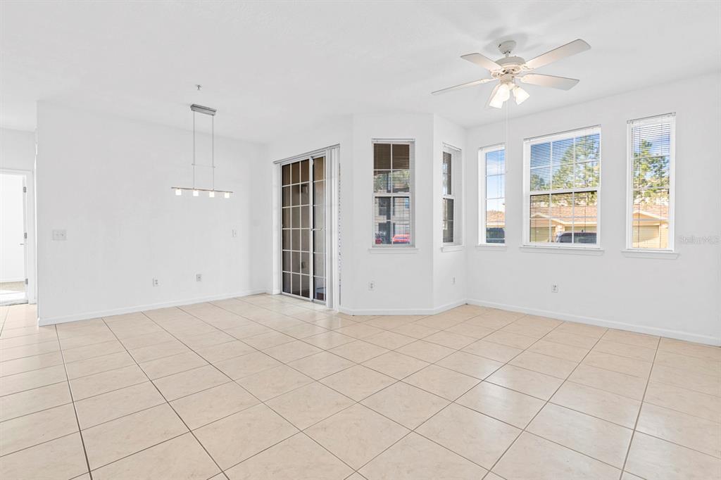 707 Terrace Ridge Circle, Unit 707 Davenport, FL 33896 - Photo 20 of 59 an empty room with windows and ceiling fan
