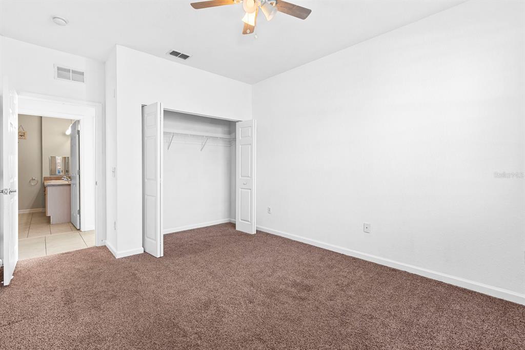 707 Terrace Ridge Circle, Unit 707 Davenport, FL 33896 - Photo 26 of 59 an empty room with a ceiling fan and a window