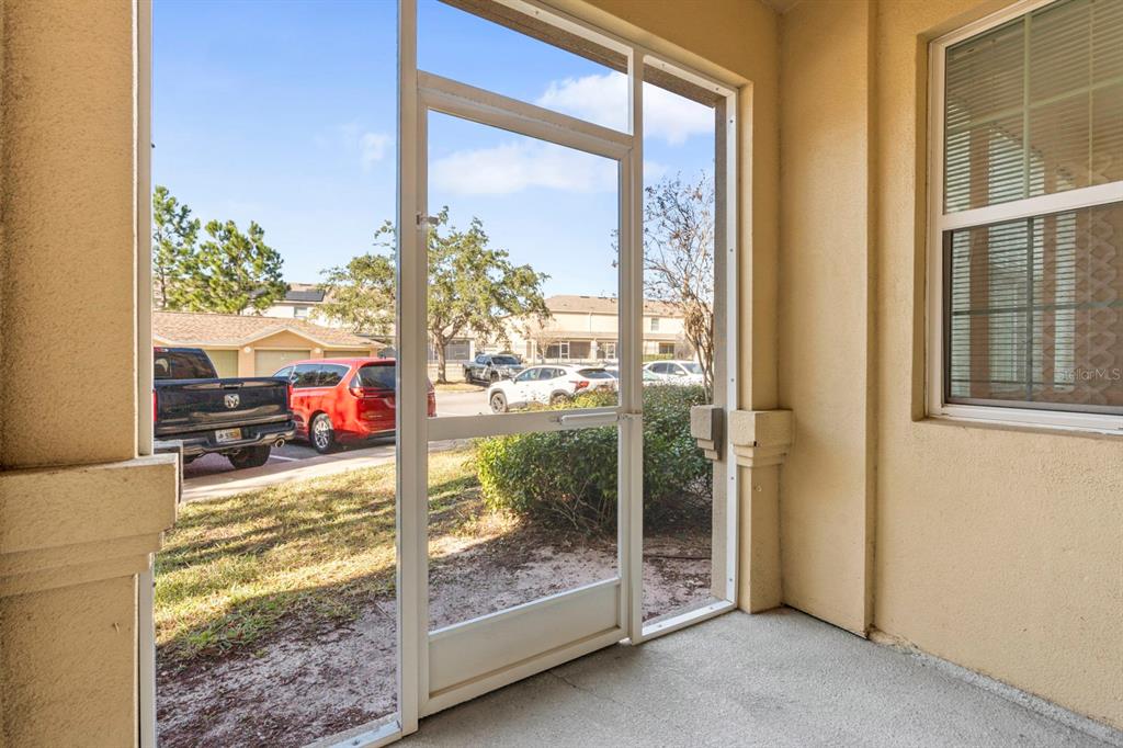 707 Terrace Ridge Circle, Unit 707 Davenport, FL 33896 - Photo 33 of 59 a room view with a floor to ceiling window and an outdoor space
