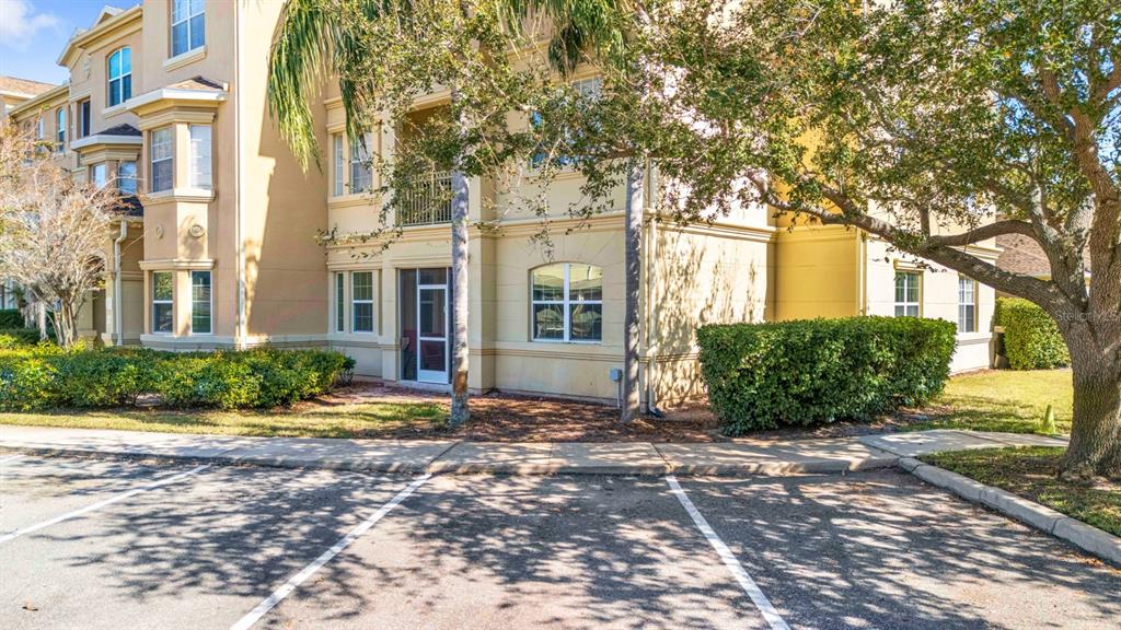 707 Terrace Ridge Circle, Unit 707 Davenport, FL 33896 - Photo 40 of 59 a view of a big house with a large windows and large tree