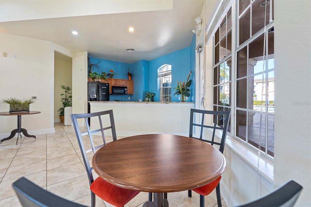 707 Terrace Ridge Circle, Unit 707 Davenport, FL 33896 - Photo 52 of 59 a view of a dining room with furniture and a rug